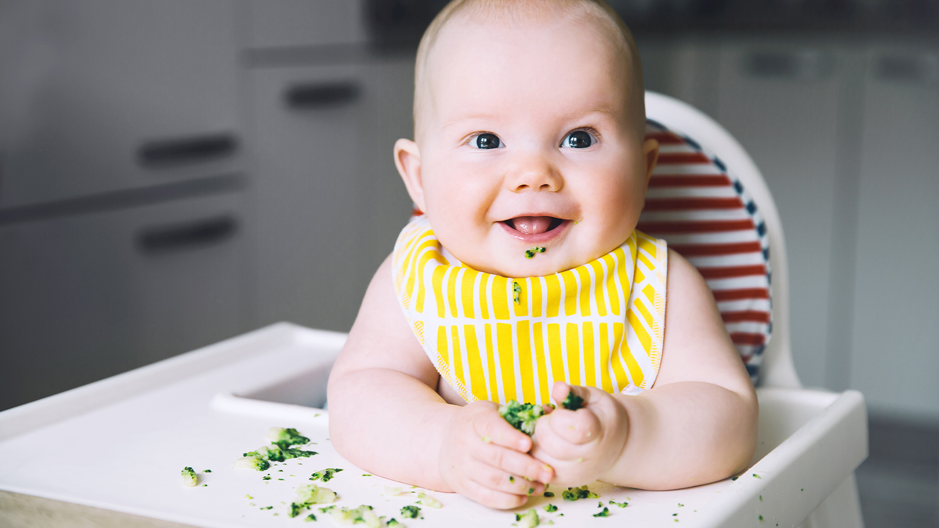 Baby eating broccoli