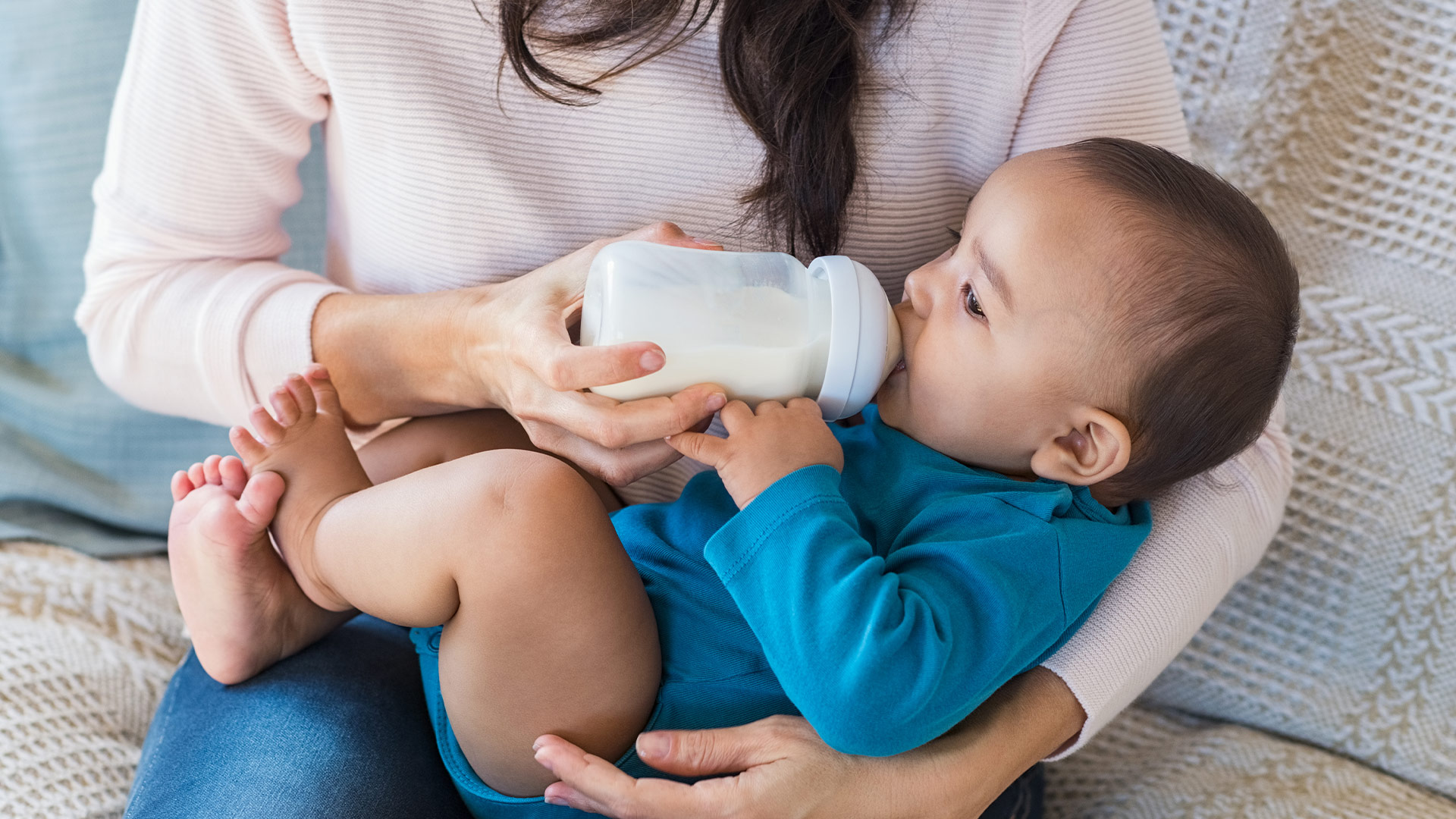 Mother bottle feeding baby