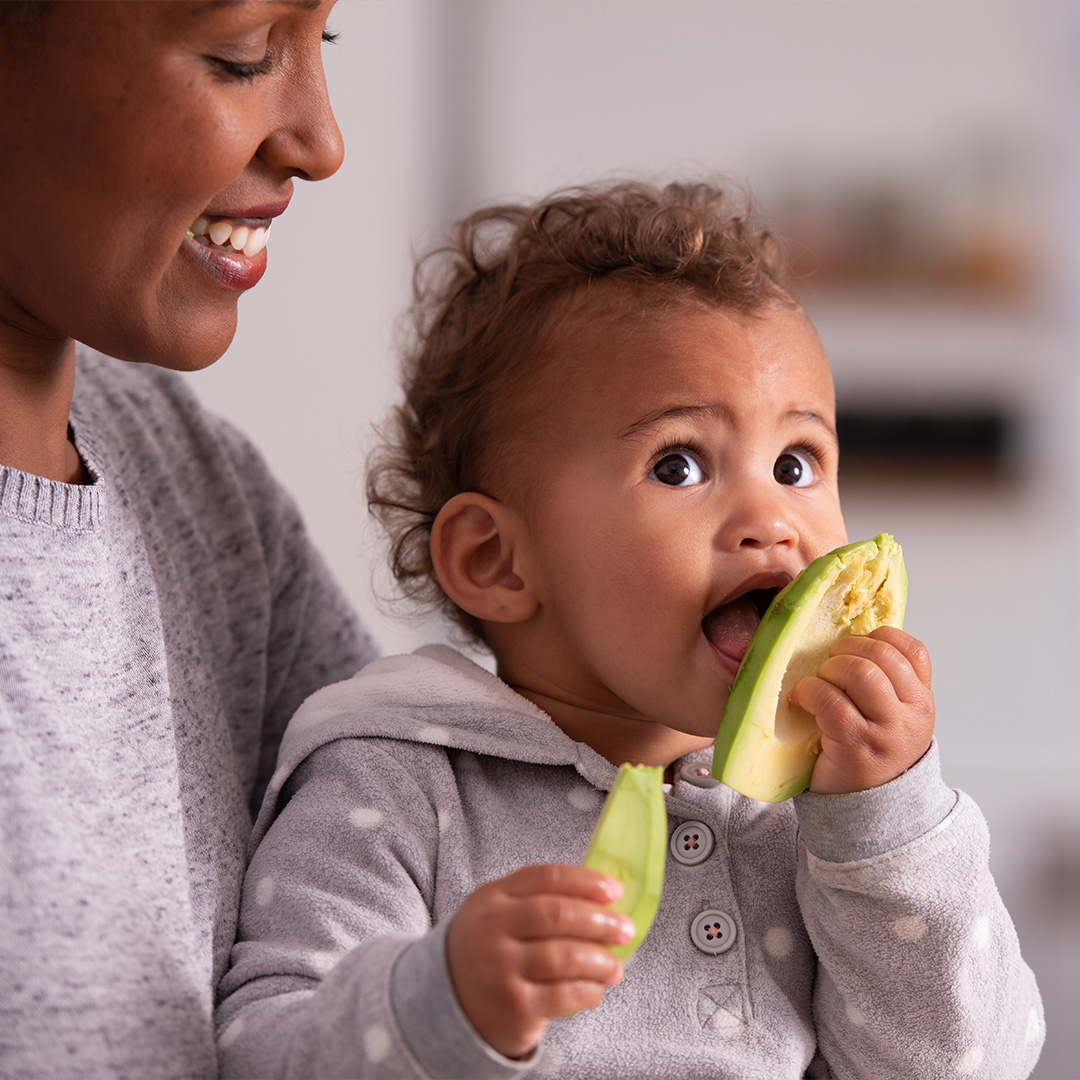 Child eating avocado