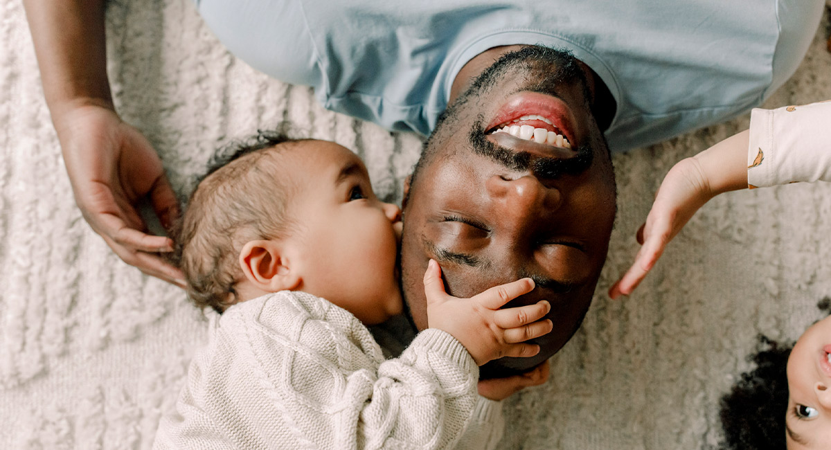 baby eating fathers face