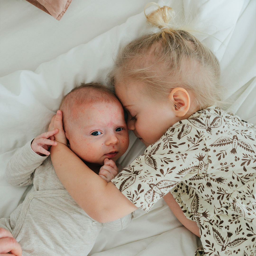 Siblings having a cozy time