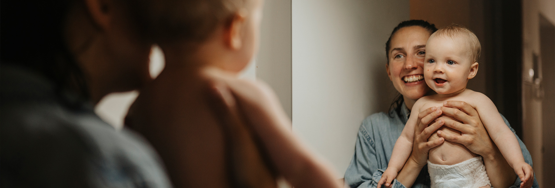 Baby and mother in mirror